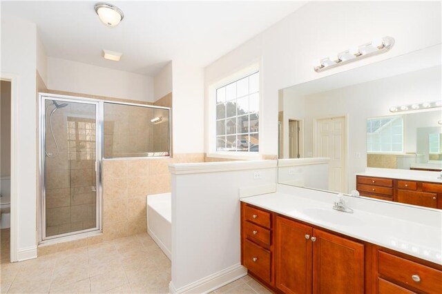 full bathroom featuring tile patterned flooring, vanity, toilet, and plus walk in shower