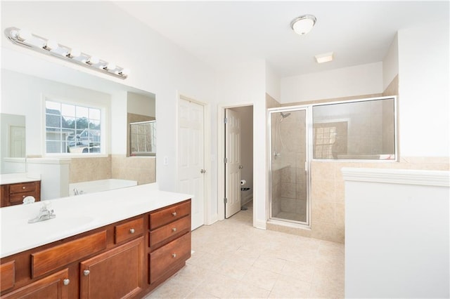 bathroom featuring tile patterned flooring, vanity, and walk in shower