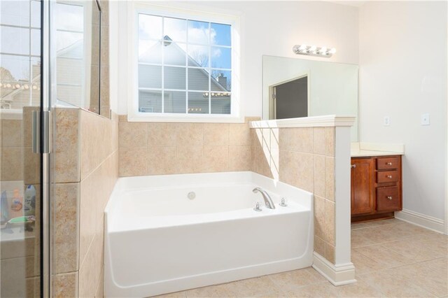 bathroom with tile patterned flooring, vanity, and separate shower and tub