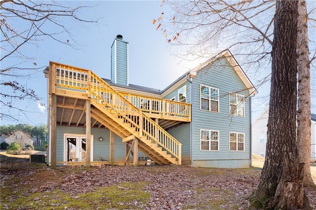 rear view of house featuring a deck, central air condition unit, and french doors