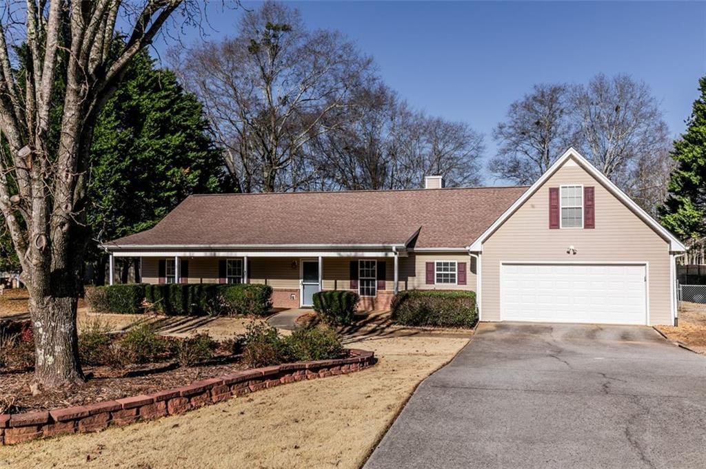 view of front of home with a garage and a porch