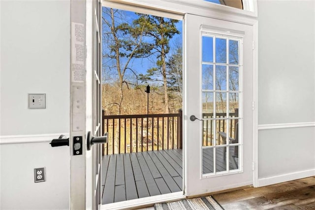 entryway with baseboards and wood finished floors