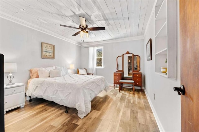 bedroom with crown molding, baseboards, and light wood-style floors