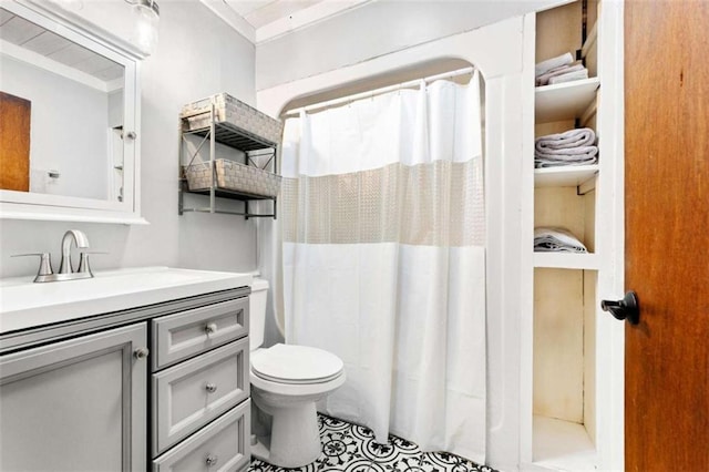bathroom featuring toilet, vanity, and a shower with curtain