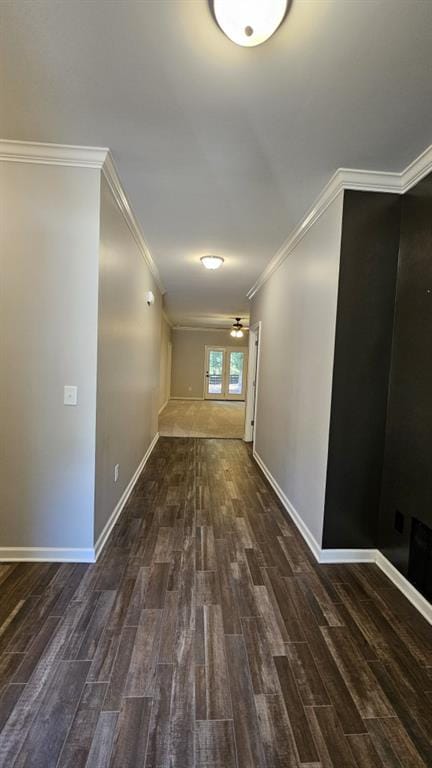 hallway featuring crown molding and dark hardwood / wood-style flooring