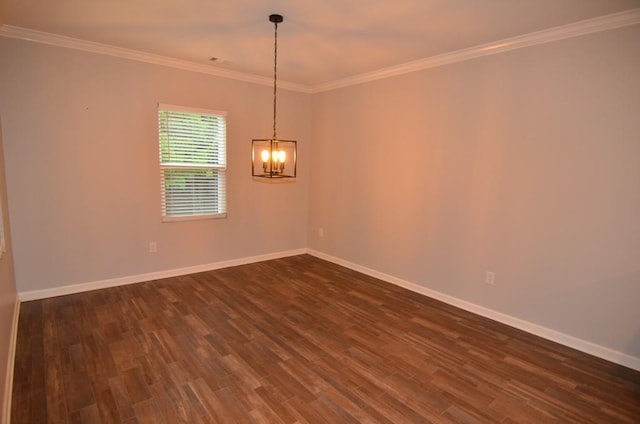 spare room with crown molding, dark hardwood / wood-style floors, and a notable chandelier