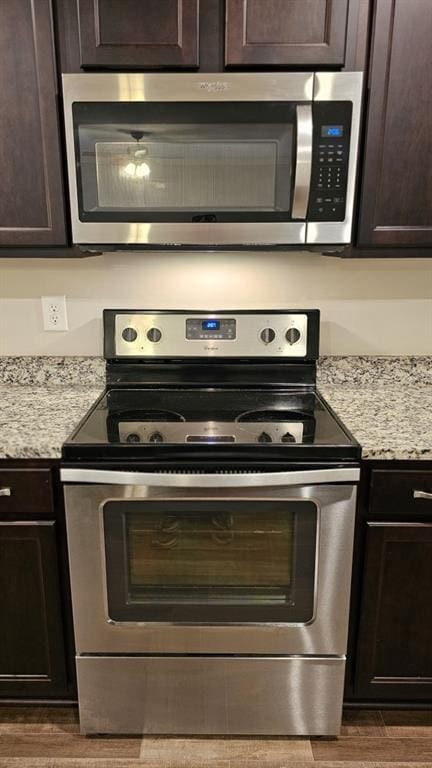 kitchen featuring stainless steel appliances and dark brown cabinets