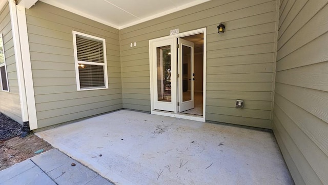 view of exterior entry featuring a patio area