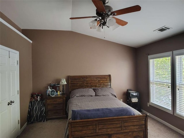 bedroom with ceiling fan, visible vents, carpet floors, baseboards, and lofted ceiling