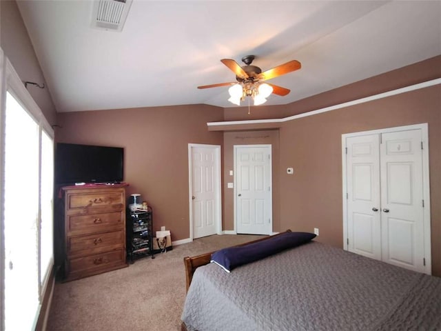 bedroom with ceiling fan, carpet, baseboards, lofted ceiling, and visible vents