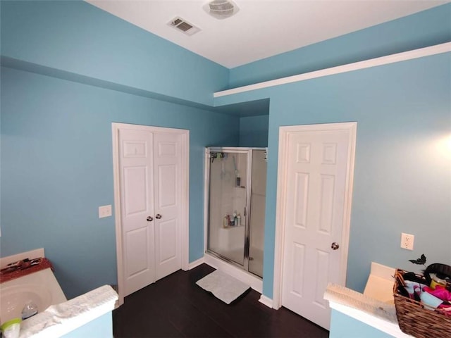 full bathroom with visible vents, wood finished floors, a stall shower, and vanity