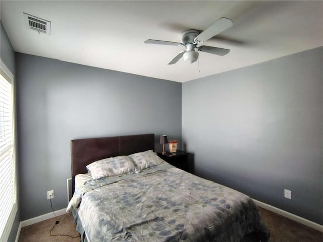 bedroom featuring visible vents, a ceiling fan, baseboards, and carpet floors