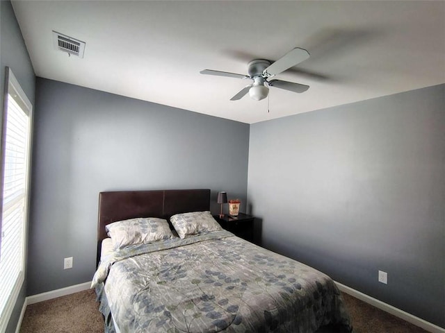bedroom with carpet floors, baseboards, ceiling fan, and visible vents