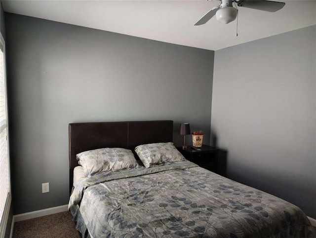 carpeted bedroom featuring baseboards and ceiling fan