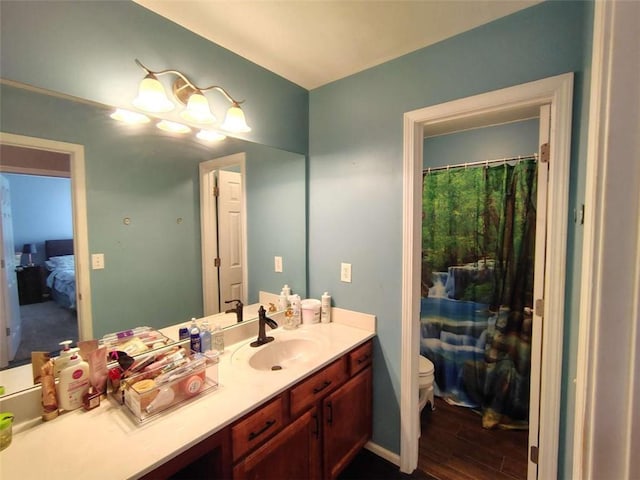 bathroom featuring vanity, wood finished floors, toilet, and curtained shower