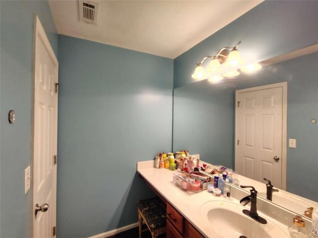 bathroom with baseboards, visible vents, and vanity