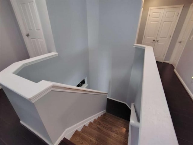 stairs with baseboards and wood finished floors