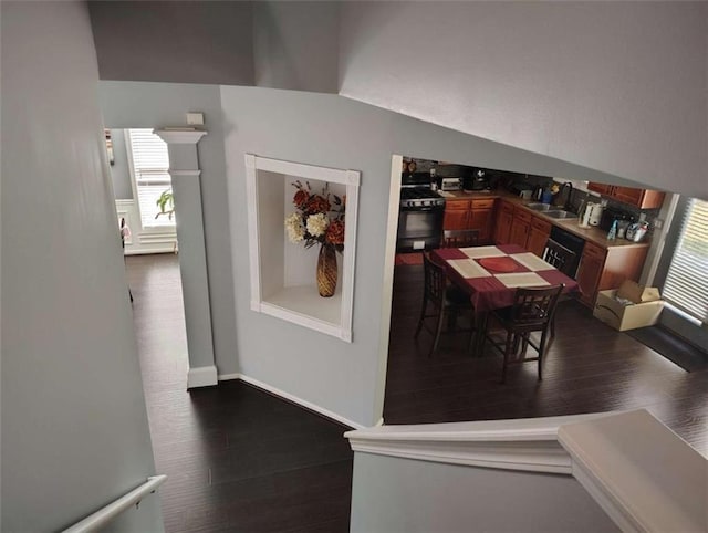 dining space featuring dark wood finished floors and a wealth of natural light