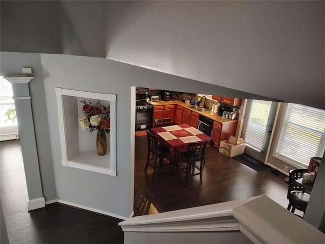 dining space with a dry bar and dark wood-type flooring