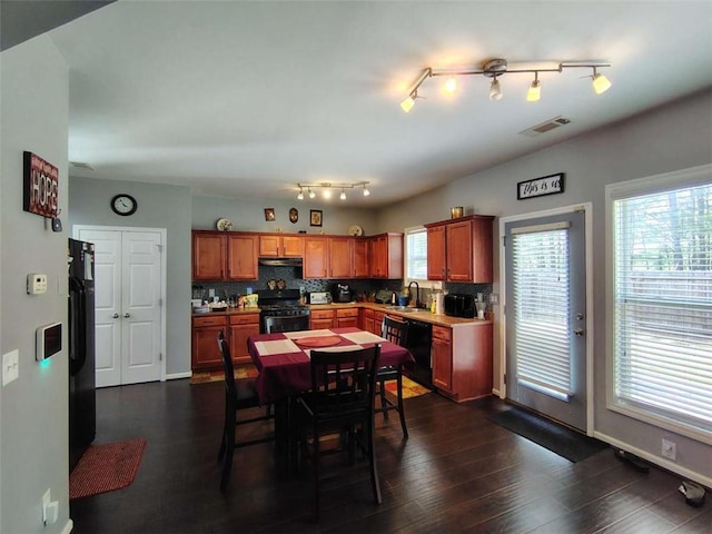 dining space featuring visible vents, rail lighting, dark wood finished floors, and baseboards