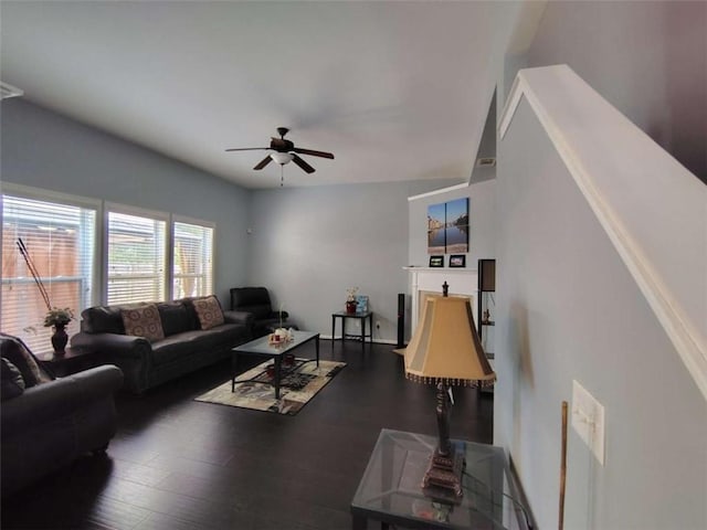 living area featuring a ceiling fan and wood finished floors