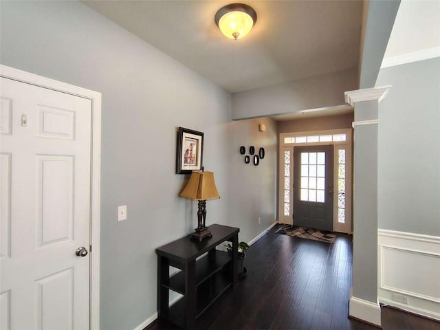 foyer with baseboards and dark wood-style flooring