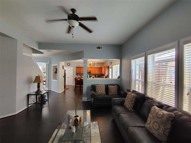 living area with baseboards, a ceiling fan, ornate columns, and visible vents