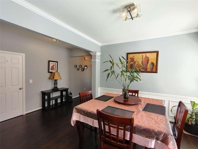 dining space featuring ornate columns, ornamental molding, and dark wood-type flooring