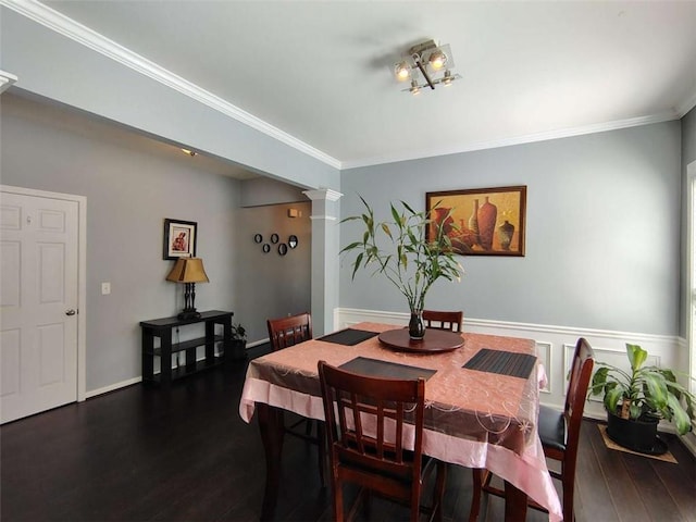 dining space with crown molding, decorative columns, and dark wood-style floors