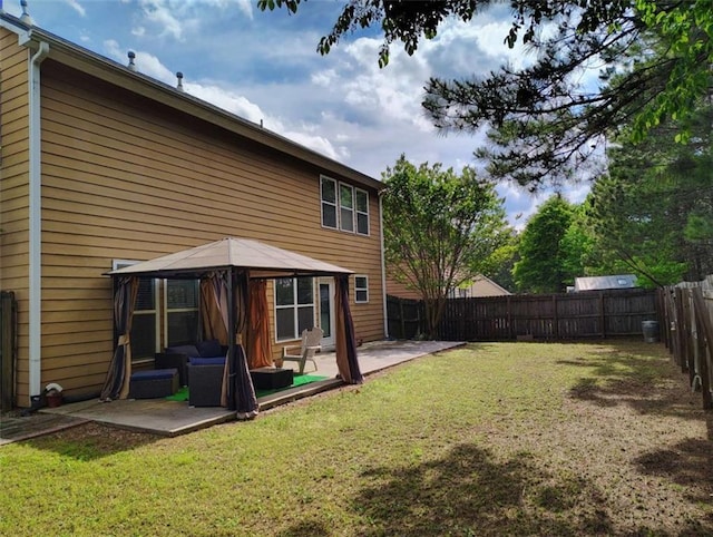 rear view of house with an outdoor living space, a gazebo, a fenced backyard, a yard, and a patio