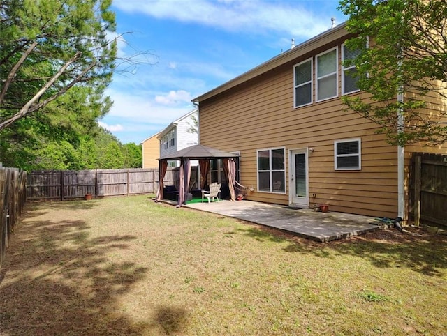 back of house featuring a gazebo, a fenced backyard, a patio area, and a lawn