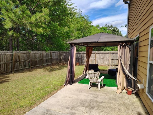 view of patio featuring a gazebo and a fenced backyard