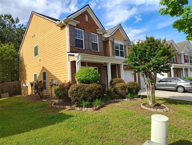 view of front of house with brick siding, a garage, fence, and a front yard