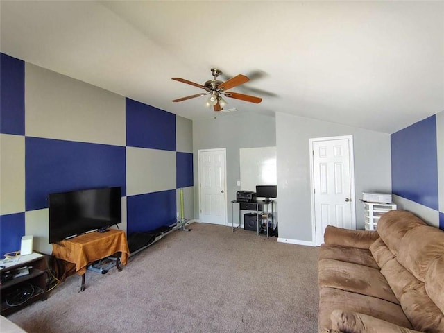 living room with baseboards, carpet, ceiling fan, and lofted ceiling
