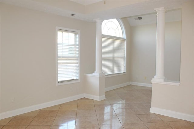 tiled empty room with a healthy amount of sunlight