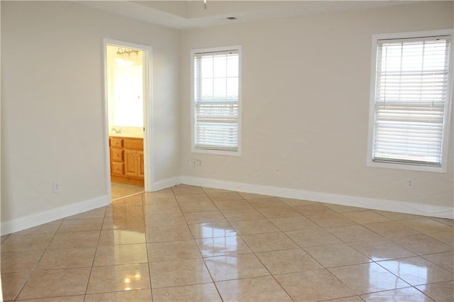 spare room featuring light tile patterned floors