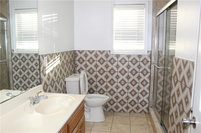 bathroom featuring tile patterned floors, vanity, toilet, and a wealth of natural light