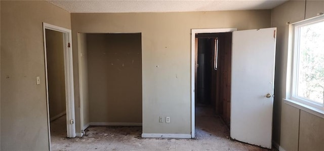 unfurnished bedroom with a textured ceiling