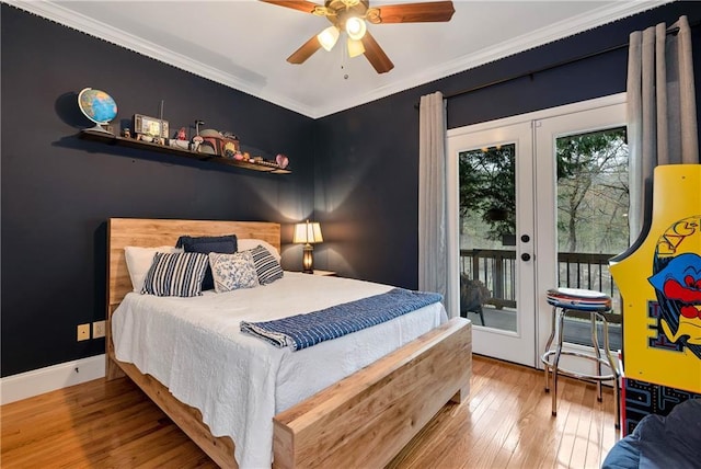 bedroom featuring access to outside, baseboards, ornamental molding, french doors, and hardwood / wood-style flooring