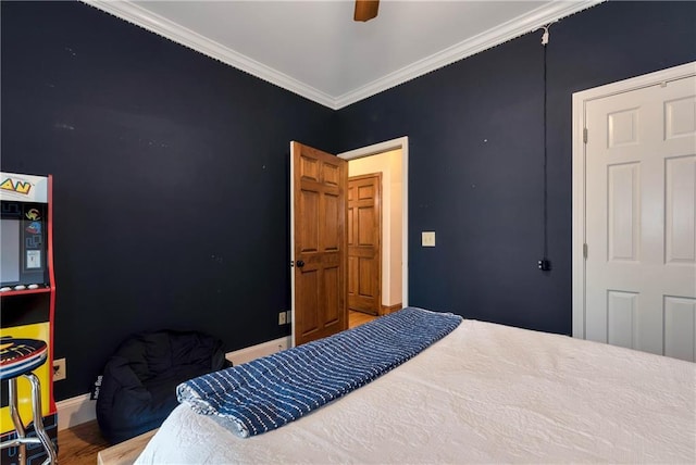 bedroom featuring baseboards, crown molding, and a ceiling fan