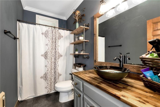 full bathroom with ornamental molding, toilet, curtained shower, and vanity