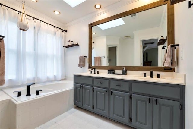 bathroom with a sink, ornamental molding, double vanity, a skylight, and a relaxing tiled tub