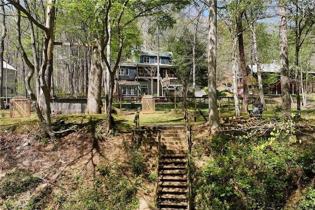 view of yard with stairway and fence