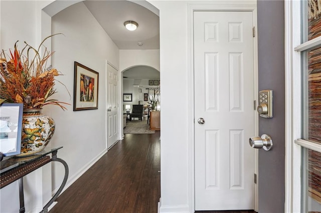 corridor with dark hardwood / wood-style flooring