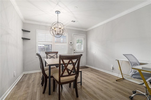 115 Winding River Dr Unit B, Atlanta, GA 30350 - dining space featuring a chandelier, wood finished floors, and ornamental molding