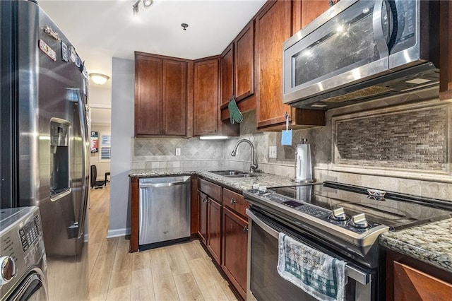 115 Winding River Dr Unit B, Atlanta, GA 30350 - kitchen with appliances with stainless steel finishes, light stone counters, light wood-style floors, and washer / clothes dryer