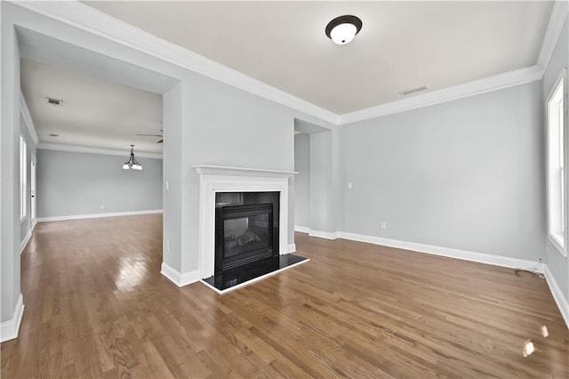 120 Daniel Creek Ln, Sugar Hill, GA 30518 - unfurnished living room with ornamental molding, wood finished floors, and a glass covered fireplace