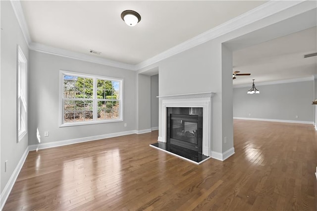 120 Daniel Creek Ln, Sugar Hill, GA 30518 - unfurnished living room with a glass covered fireplace, ornamental molding, wood finished floors, and a ceiling fan