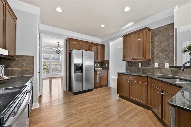 120 Daniel Creek Ln, Sugar Hill, GA 30518 - kitchen featuring appliances with stainless steel finishes, a chandelier, decorative backsplash, dark stone counters, and crown molding