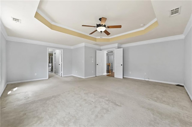 120 Daniel Creek Ln, Sugar Hill, GA 30518 - unfurnished bedroom featuring a tray ceiling, ornamental molding, carpet floors, ensuite bath, and a ceiling fan